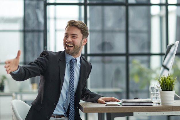 Hello by Man in Office Indoor Waving Hand