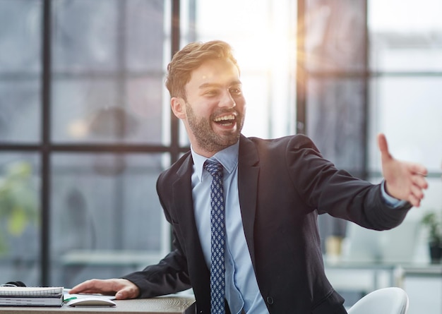 Photo hello by man in office indoor waving hand