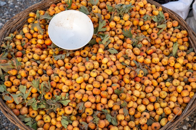 hello dry fruits with a small bowl on the top is some of the leaves in the scattered fruit basket