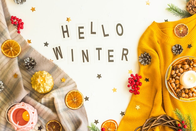 Hello winter. Written in black letters on a blured background 