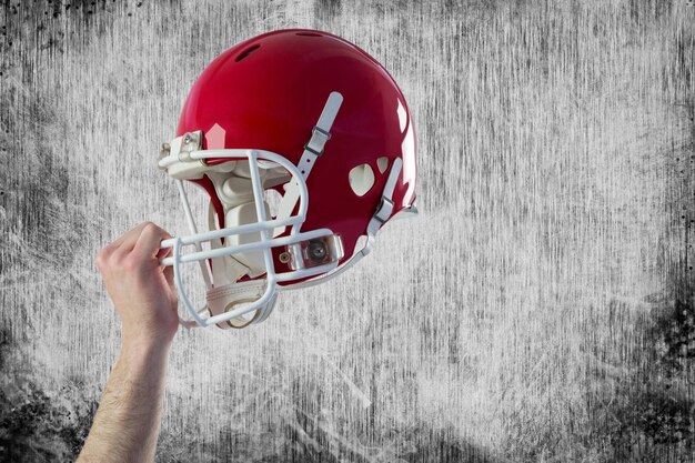 Photo helmet of  an american football player  against grey background