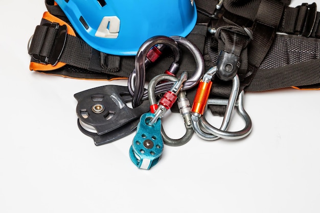 Helmet for work at height or mountaineering Equipment for mountaineering and highaltitude works carabiners closeup on a white background Empty place