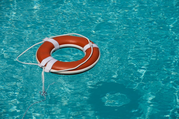 Help and drowning concept life saver ring floating in the water