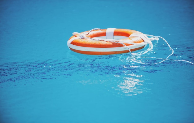 Help and drowning concept life saver ring floating in the water