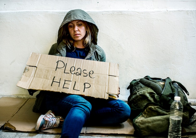 help person holding homeless adult begging