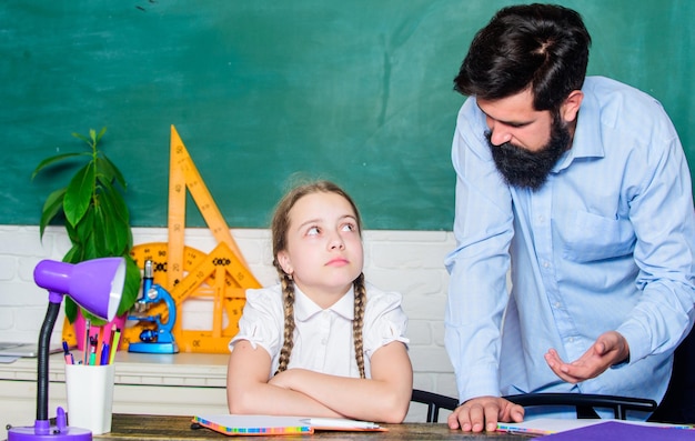 Help and support education child development daughter study with father Teachers day bearded man teacher with small girl in classroom back to school knowledge day Home schooling