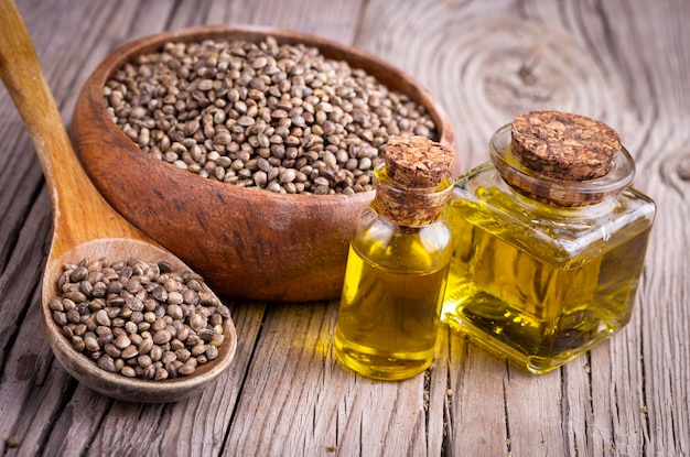 Hemp seeds and hemp seed oil on wooden background