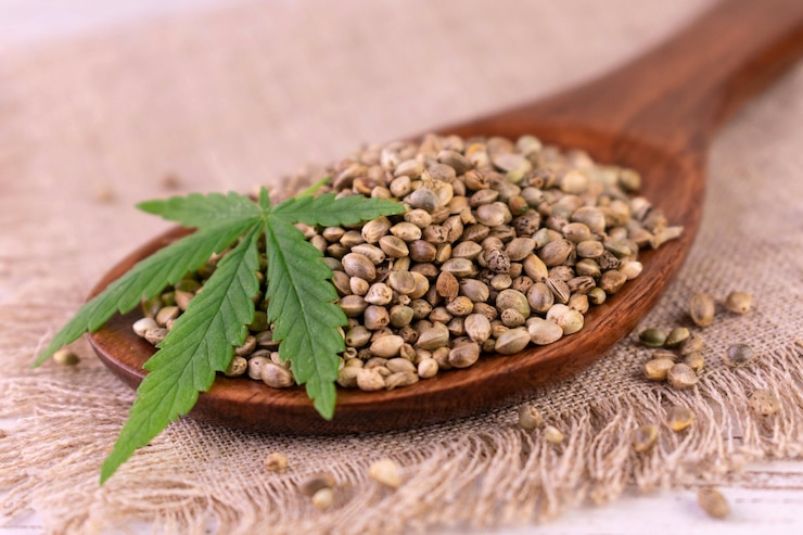 Photo hemp seeds in a wooden spoon. cannabis.