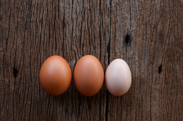 Hen eggs on wood background. Top View.