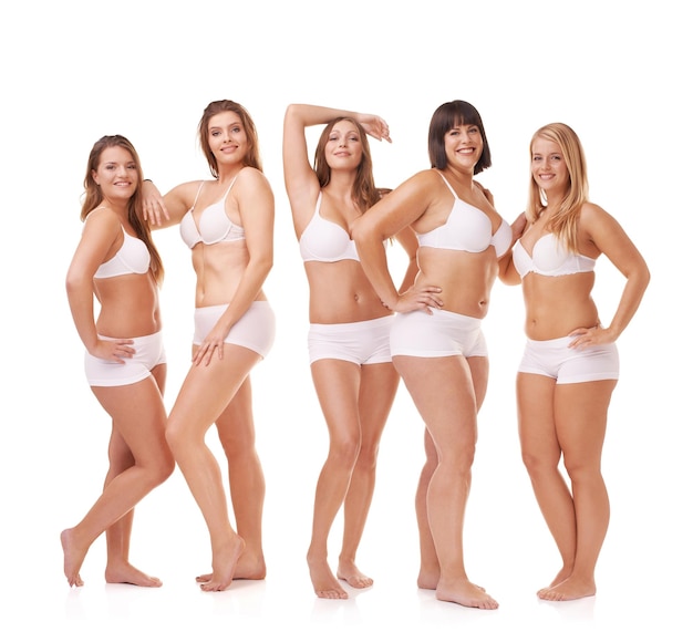 Her confidence is all natural. A group of women with different body shapes standing together in their underwear while isolated on white.