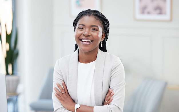 her joy shines from within. Shot of a young businesswoman taking a break in her office.