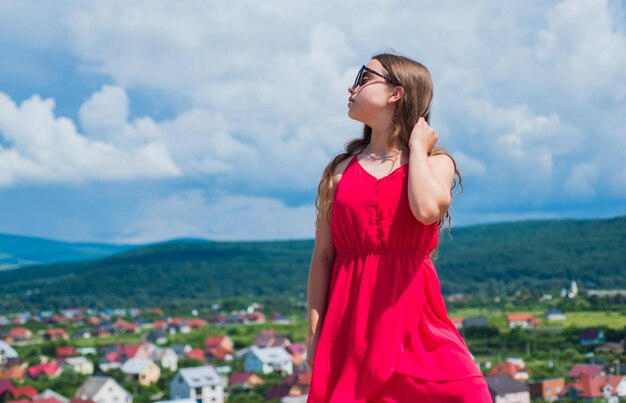 In her own style sense of freedom Stylish fashion child baby girl kid outdoor stylish cute child posing in spring Summer fun and leisure concept fashion model posing her trendy style