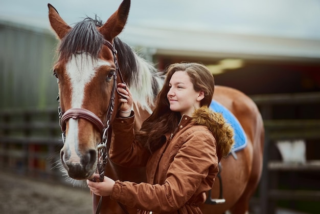 Her pony her first love Shot of a teenage girl standing next to her pony on a farm