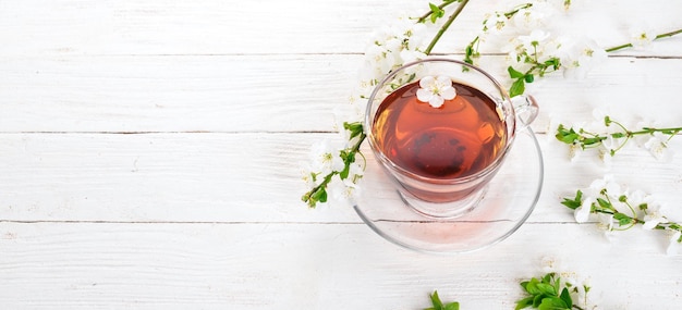 Herb tea with flowers on a wooden background top view copy\
space