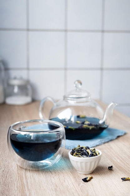 Herbal blue tea, glass cup and teapot with anchan.