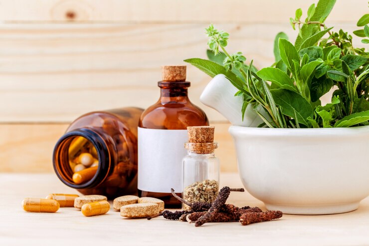 Herbal capsule on wooden background.