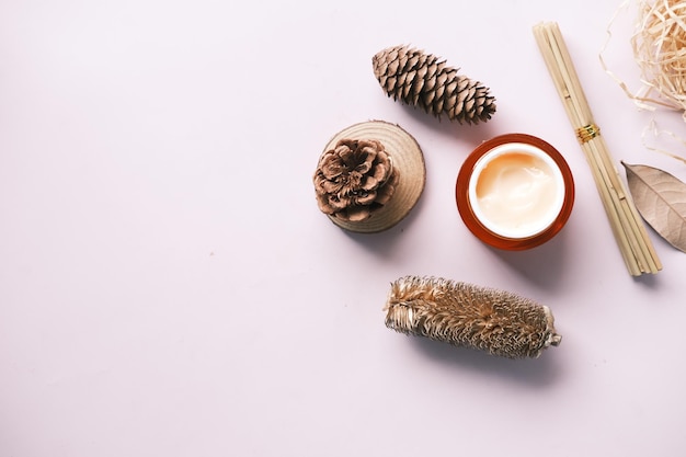 Herbal cream cosmetic in a container on table