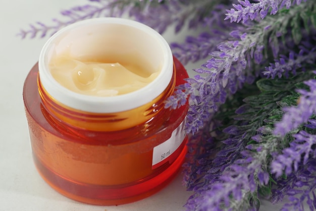 Herbal cream cosmetic in a container on table