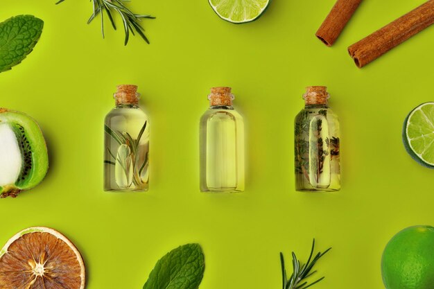 Photo herbal essential oil bottles flat lay on green background