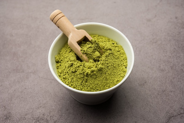 Herbal henna or Mehandi powder in a bowl forming heap, Used for Tattoo or Hair Dye 