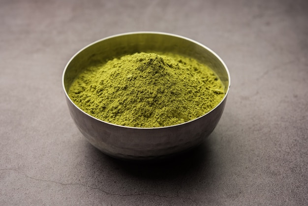 Herbal henna or Mehandi powder in a bowl forming heap, Used for Tattoo or Hair Dye 