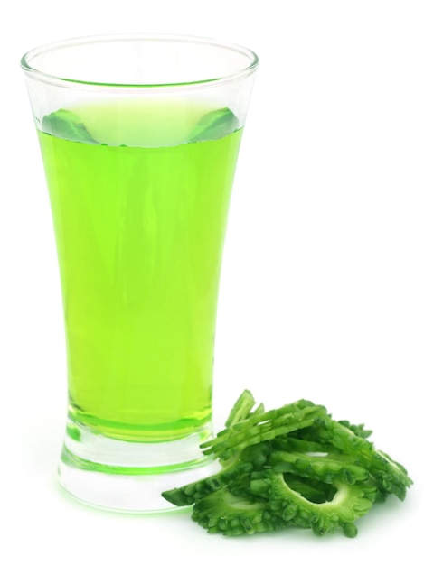 Herbal juice of green momodica over white background