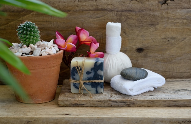 Herbal massage ball and indigo soap spa aromatherapy products decor with cactus pot on wooden table