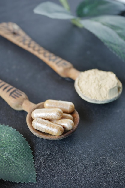 Herbal medicine capsule on spoon