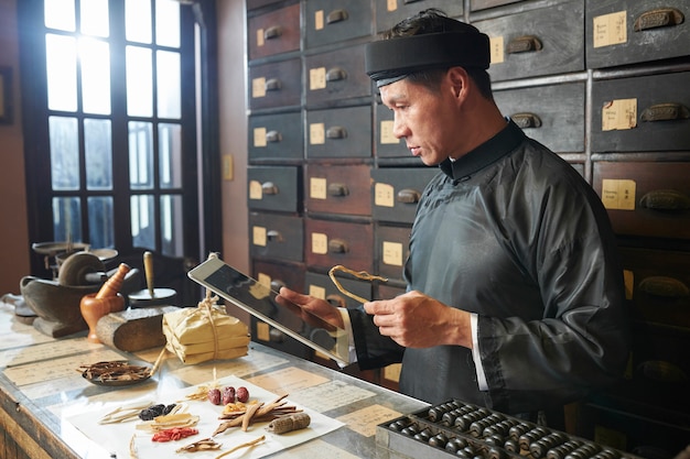 Herbal medicine practitioner making traditional remedy