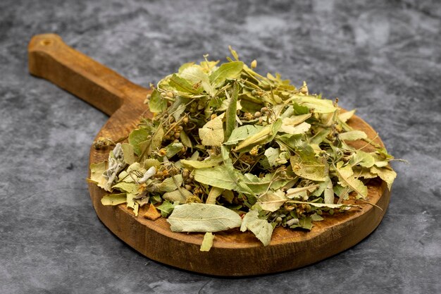 Herbal tea on a dark background linden tea medicinal tea
prepared from linden leaves clove particles and chamomile