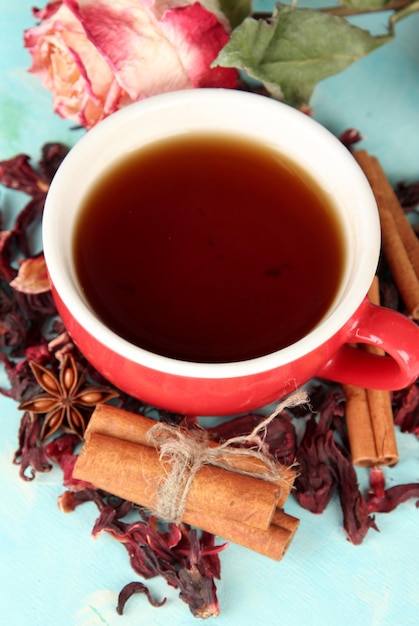 Herbal tea in glass cup on color wooden background