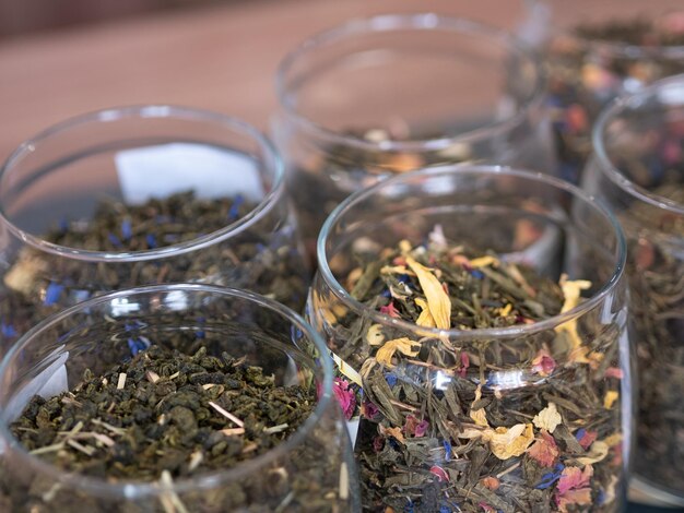 Herbal tea in glass jars lined up on a store shelf