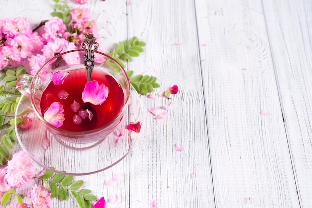 Herbal tea ingredients with flowers and cup of tea