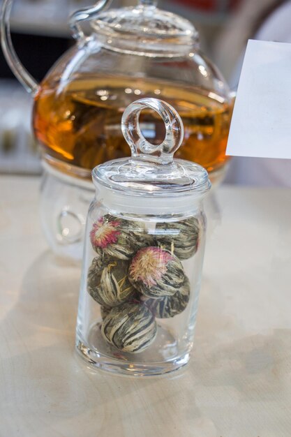 Photo herbal tea in teapot and tea plant in a bottle