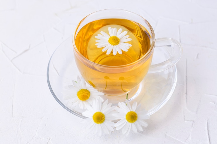 Photo herbal tea with chamomile in a glass cup.  healthy lifestyle proper nutrition vitamins and antioxidants