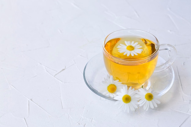 Herbal tea with chamomile in a glass cup with copy space Healthy lifestyle Proper nutrition Vitamins and antioxidants