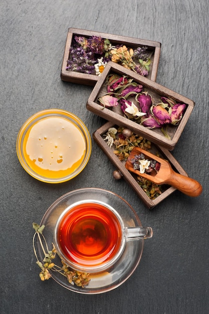 Herbal tea with honey dried herbs and flowers top view