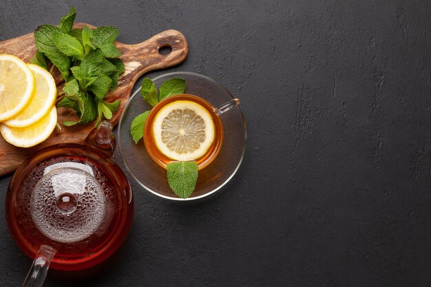 Herbal tea with mint and lemon Tea cup and teapot