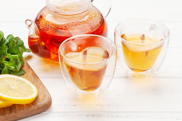 Herbal tea with mint and lemon tea cup and teapot