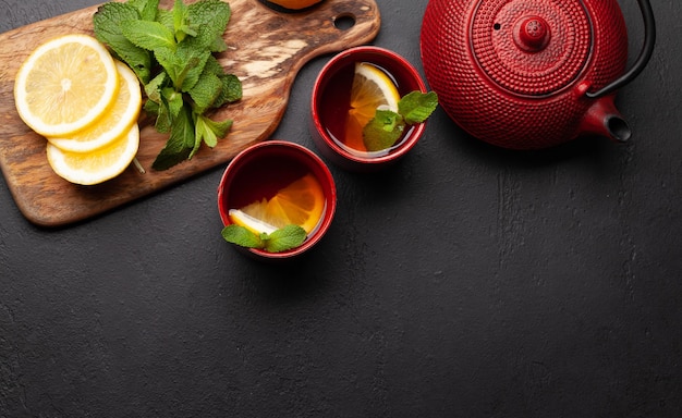 Herbal tea with mint and lemon Tea cup and teapot