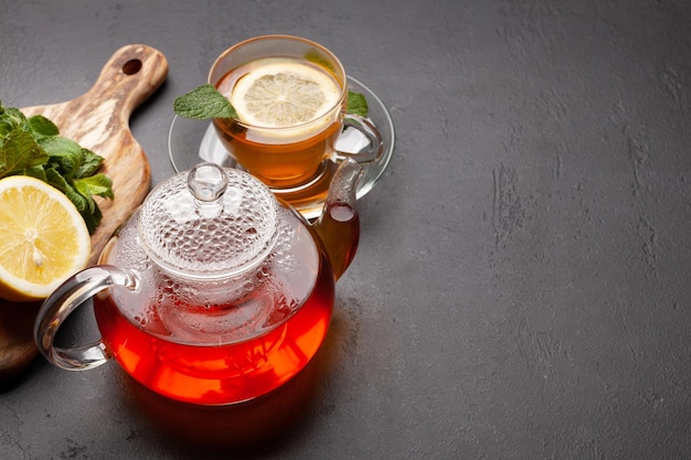 Herbal tea with mint and lemon Tea cup and teapot