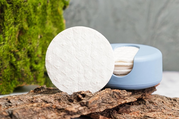 Herbruikbare Cotton Rounds make-up remover in een container gemaakt van gerecycled oceaanplastic op boomschors Zero waste pads om milieuvervuiling te verminderen