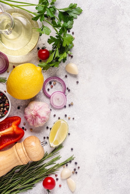 Photo herbs and condiments on light stone background