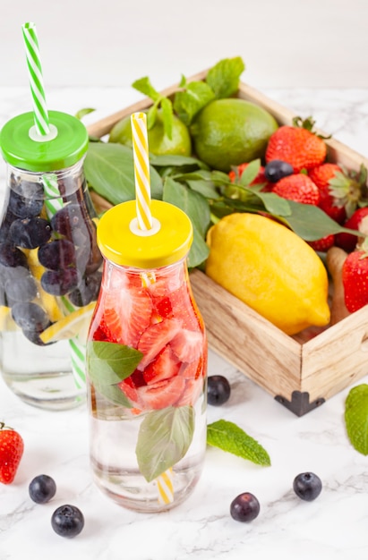 Herbs and fruits flavored infused water. Summer refreshing drink. Health care, fitness, healthy nutrition diet concept.