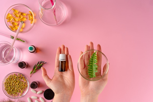 Herbs and Herbal dietary supplements top view on pink background