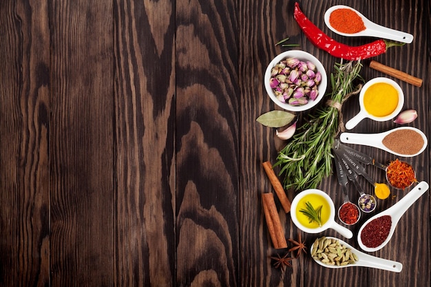 Herbs and spices over wood background