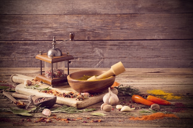 Herbs and spices on a wooden background