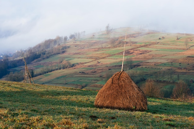 Herfstlandschap met een stapel droog hooi Bergdorp Morgennevel