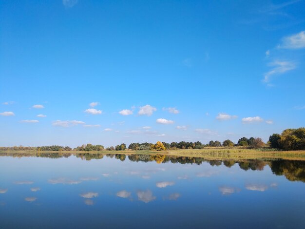 Foto herfstreflecties met bomen en wolken