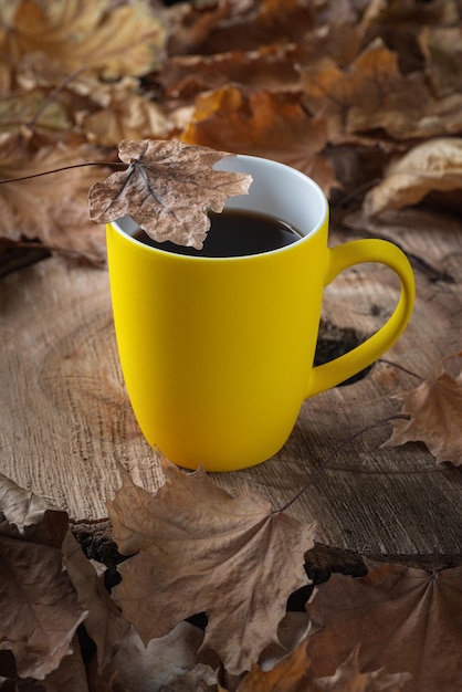 Herfststilleven met een kopje koffie en gevallen bladeren